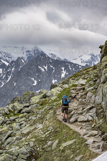 Two mountaineers on a hiking trail, view of glaciated rocky mountain peaks, Berliner Hoehenweg, Zillertal Alps, Tyrol, Austria, Europe
