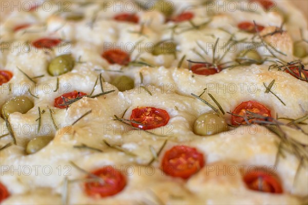 Homemade Italian flatbread Focaccia with cherry tomatoes, olives and rosemary