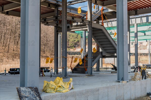 Chungju, South Korea, March 22, 2020: For editorial use only. Stairway to second floor of metal frame industrial building at rural construction site, Asia
