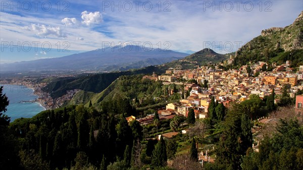 Mount Etna, panoramic view of a coastal town with mountains in the background and clear sky, Taormina, Eastern Sicily, Sicily, Italy, Europe