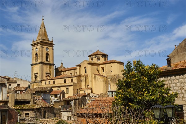View over the roofs of an old town with church and trees under a blue sky, Novara di Sicilia, Sicily, Italy, Europe