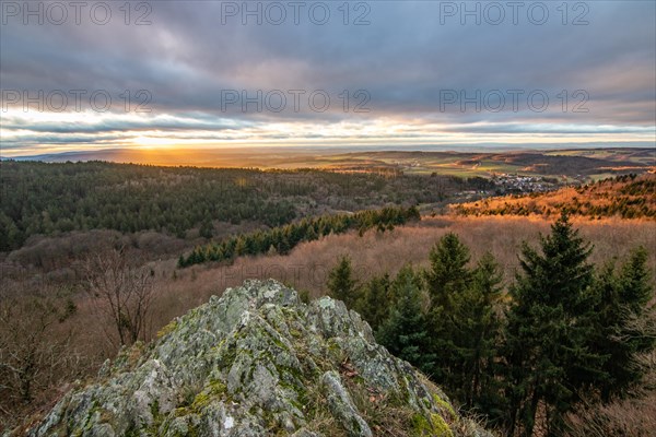 Landscape at the Grosser Zacken, Taunus volcanic region. A cloudy, sunny autumn day, meadows, hills, fields and forests with a view of the sunset. Hesse, Germany, Europe