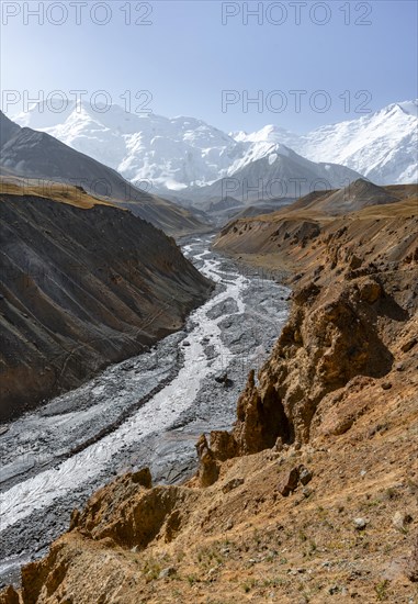 Achik Tash river, Achik Tash valley with rock formations, behind glaciated and snow-covered mountain peak Pik Lenin, Trans Alay Mountains, Pamir Mountains, Osh Province, Kyrgyzstan, Asia