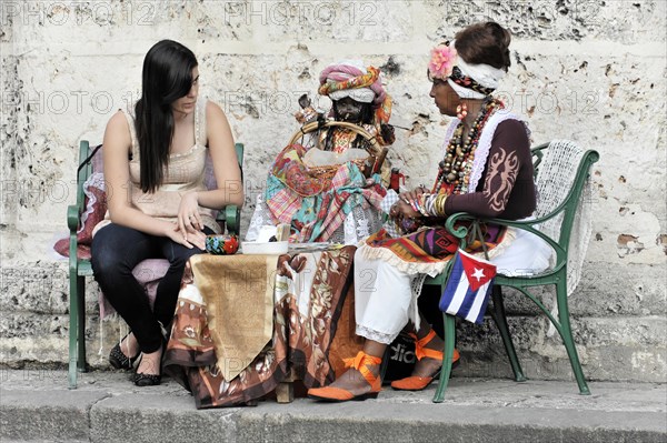 Fortune teller with tourist, Havana, Cuba, Greater Antilles, Caribbean, Central America