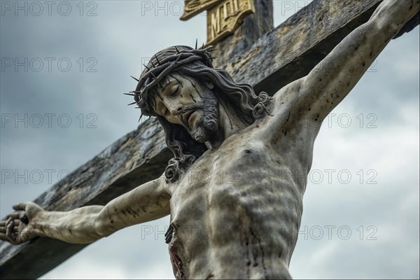 Statue of Jesus on the cross with crown of thorns under a cloudy sky, conveys a sense of suffering and sacrifice, AI generated, AI generated