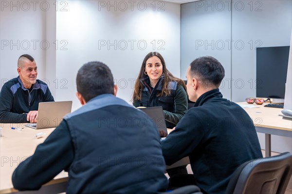 Team of coworkers engineers during a meeting in room of factory