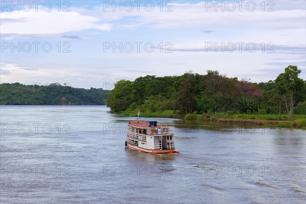 Traditional wooden boat navigating on the Tapajos River, Para state, Brazil, South America