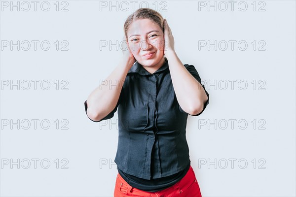 Displeased girl in glasses covering her ears isolated. Frustrated woman covering her ears tightly