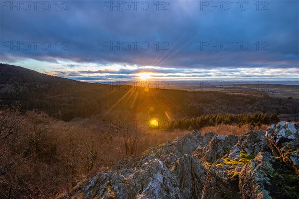 Landscape at the Grosser Zacken, Taunus volcanic region. A cloudy, sunny autumn day, meadows, hills, fields and forests with a view of the sunset. Hesse, Germany, Europe