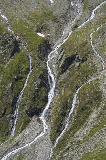 Waterfalls on a green mountainside, Berliner Hoehenweg, Zillertal Alps, Tyrol, Austria, Europe