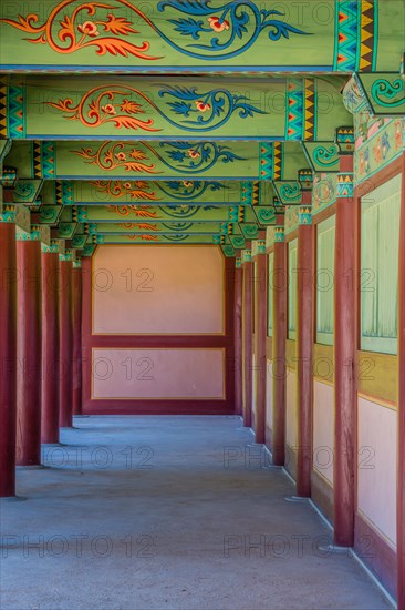 Buyeo, South Korea, July 7, 2018: Walkway under pavilion with details of colorful ceiling at Neungsa Baekje Temple, Asia