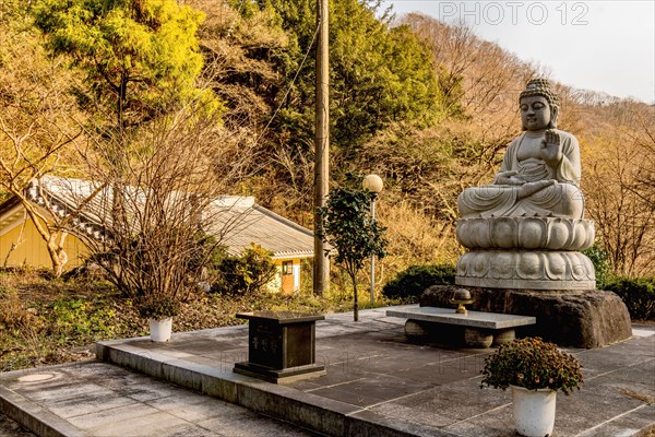 Stone carved sitting Buddha at Buddhist temple