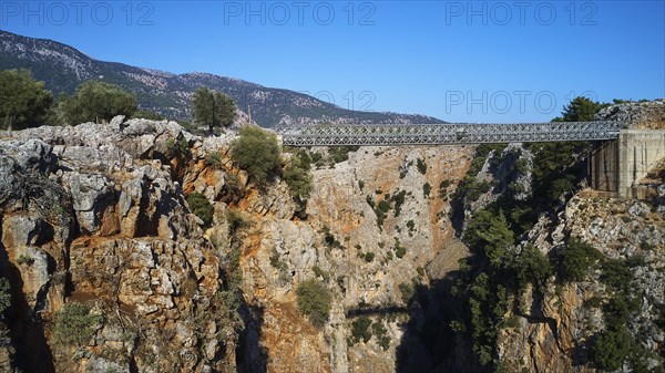 Metallic bridge over a deep gorge surrounded by a mountainous landscape, Aradena Gorge, Aradena, Sfakia, Crete, Greece, Europe