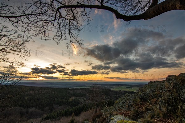 Landscape at the Grosser Zacken, Taunus volcanic region. A cloudy, sunny autumn day, meadows, hills, fields and forests with a view of the sunset. Hesse, Germany, Europe