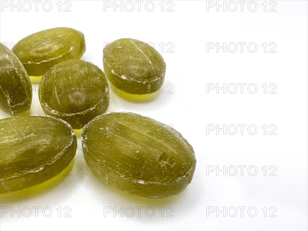 Green mint candies on isolated background with copy space. View of green mint candies on white background with space for text