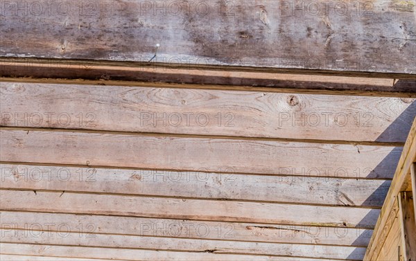 Rows of wooden rafters over patio on sunny day