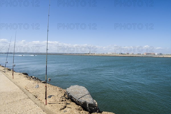 Fishing from the pier on Atlantic Ocean in Isla Canela in Andalusia, southern Spain