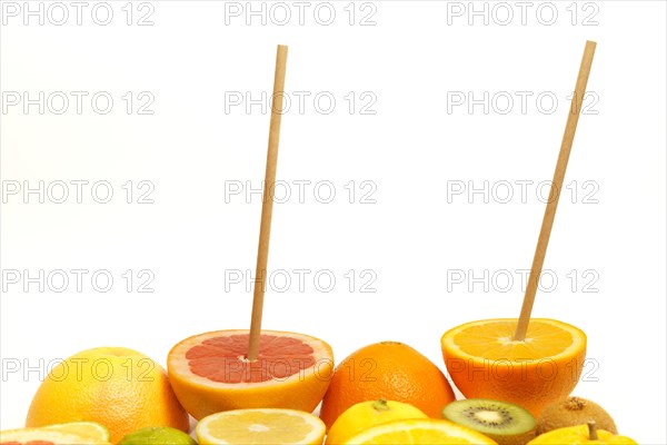 Fresh fruit cut in half with a drinking straw isolated on a white background .orange, grapefruit, lemon, kiwi fruit