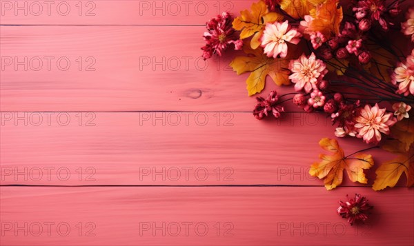 Flat lay of faux autumn leaves and flowers on a pink wooden background AI generated