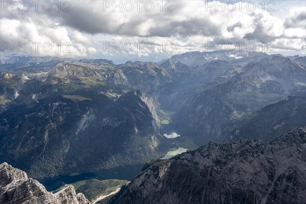 View from the rocky summit of the Watzmann Mittelspitze, view of mountain panorama with Steinernes Meer and Koenigssee, Watzmann crossing, Berchtesgaden National Park, Berchtesgaden Alps, Bavaria, Germany, Europe