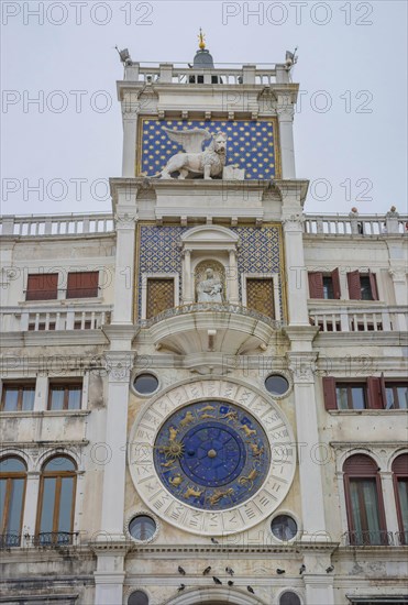 St. Mark Clock Tower (Torre dell Orologio) with Astronomical clock and winged lion statue in San Marco Square, famous tourist attraction in Venice, Italy, Europe