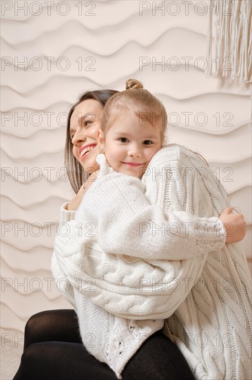 Portrait of happy young mother embracing her little baby girl