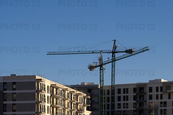 Construction cranes of new apartment buildings in Barcelona in Spain