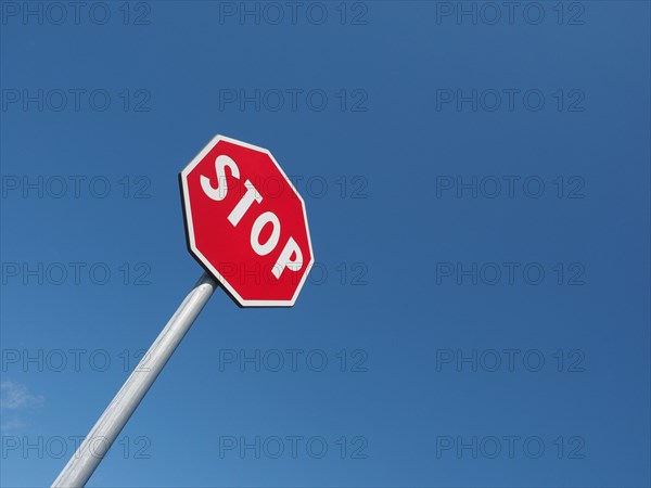 Stop sign over blue sky