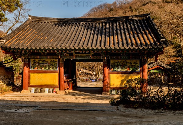 Entrance gate of Buddhist temple on sunny autumn morning