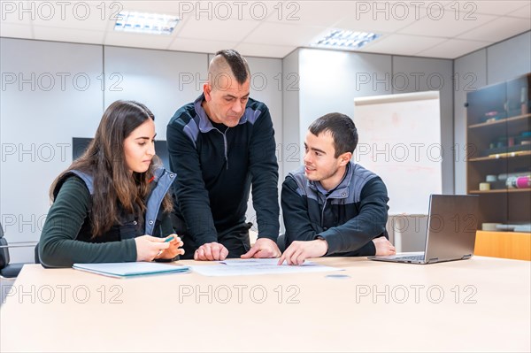 Group of diverse workers and engineers during a meeting in a factory meeting room