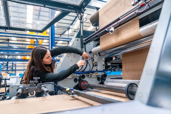 Side view with copy space of a Engineer working on a machine in a cnc modern factory