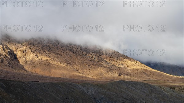 Low hanging clouds in the mountain landscape at the Tizi-n-Tichka pass road, High Atlas, Morocco, Africa