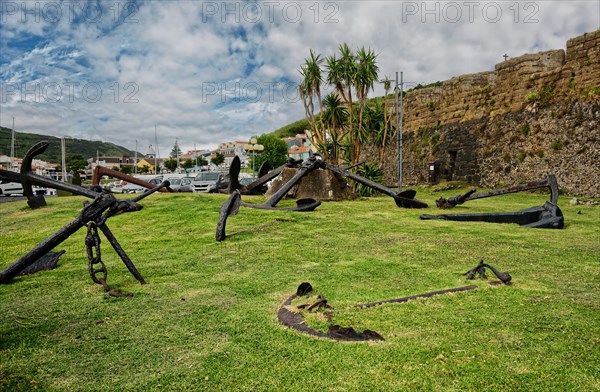 Old anchors lie on a green meadow in an open-air museum of maritime history, Horta, Faial Island, Azores, Portugal, Europe
