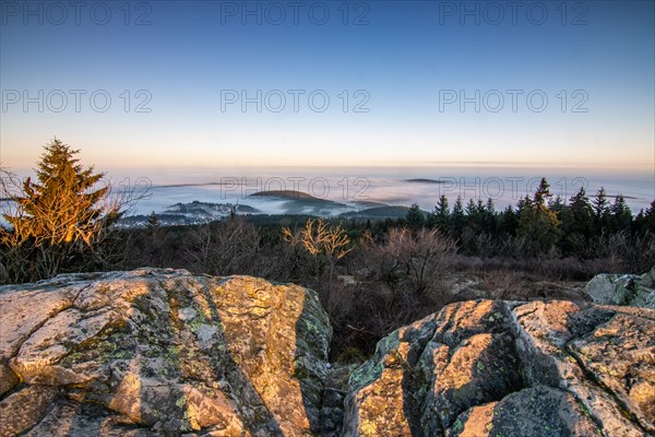 Landscape on the Grosser Feldberg, Taunus volcanic region. A cloudy, sunny winter day, meadows, hills, snow and forests with a view of the winter sunset. Hesse, Germany, Europe