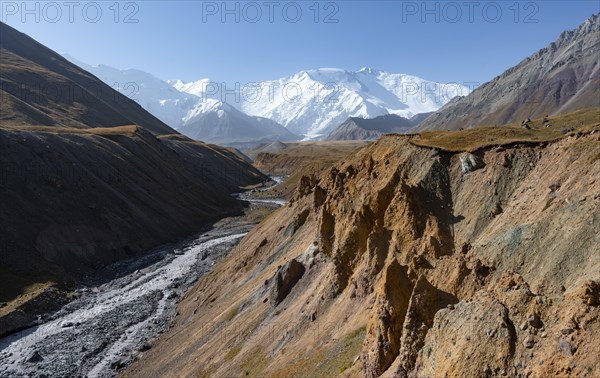 Achik Tash river, Achik Tash valley with rock formations, behind glaciated and snow-covered mountain peak Pik Lenin, Trans Alay Mountains, Pamir Mountains, Osh Province, Kyrgyzstan, Asia