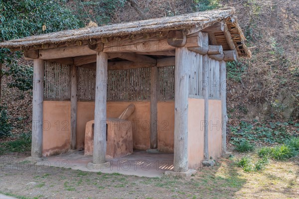 Thatched hut containing terracotta forging oven used at ship building site in Yeosu, South Korea, Asia