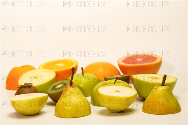 Fresh fruit cut in half isolated on a white background.pear, kiwi, apple, orange, grapefruit