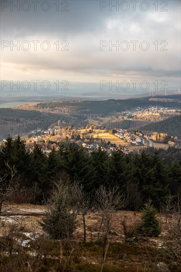 Landscape on the Grosser Feldberg, Taunus volcanic region. A cloudy, sunny winter day, meadows, hills, snow and forests with a view of the winter sunset. Hesse, Germany, Europe