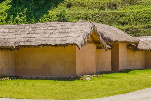 Buildings with straw thatch roofs in public park