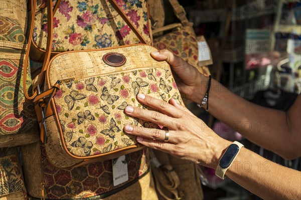 Woman buying a vintage cork bag, Coimbra