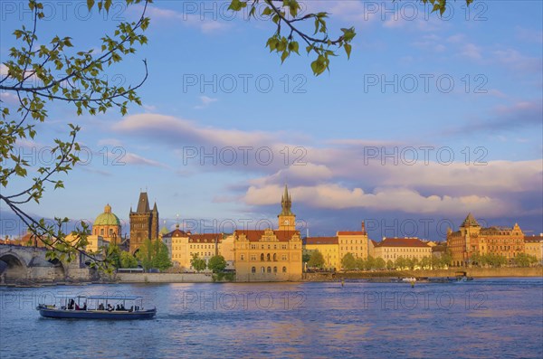 View of old town with Charles Bridge (Karluv Most) on Vltava river and Old Town Bridge Tower, famous tourist destination in Prague, Czech Republic (Czechia), at sunset