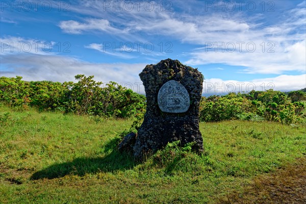 Waymarker stone of the volcanic crater and lake Lagoa do Caiado in the grass under a clear sky, Estradas dos Lagoas, Madalena, Pico, Azores, Portugal, Europe