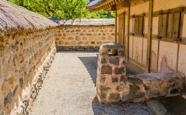Buyeo, South Korea, July 7, 2018: Stone and mud chimney attached ancient house in traditional village located in public park at Neungsa Baekje Temple. For editorial use only, Asia
