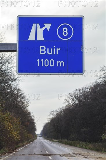 A traffic sign with a directional arrow points to the Buir motorway exit under a blue sky, abandoned A4 motorway, Lost Place, Buir, Kerpen, North Rhine-Westphalia, Germany, Europe