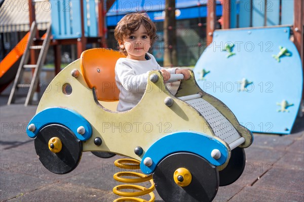 A cute little girl playing in a playground with shape of a car