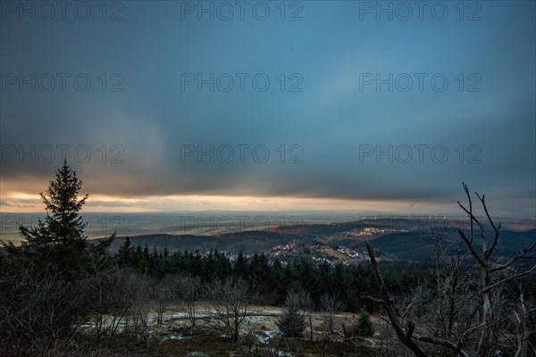 Landscape on the Grosser Feldberg, Taunus volcanic region. A cloudy, sunny winter day, meadows, hills, snow and forests with a view of the winter sunset. Hesse, Germany, Europe