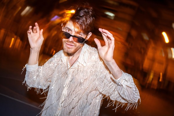Night photo with flash and motion of a man dancing in the city street at night