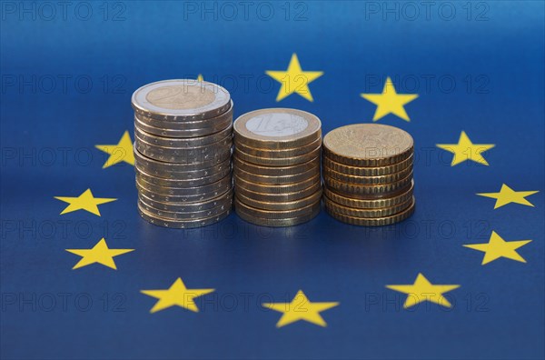 Euro coins, European Union, over flag