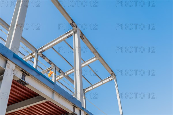 Chungju, South Korea, March 22, 2020: For editorial use only. Low angle view of second story of unfinished metal frame industrial building against clear blue sky, Asia