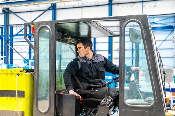 Worker driving a forklift in a modern cnc logistic factory